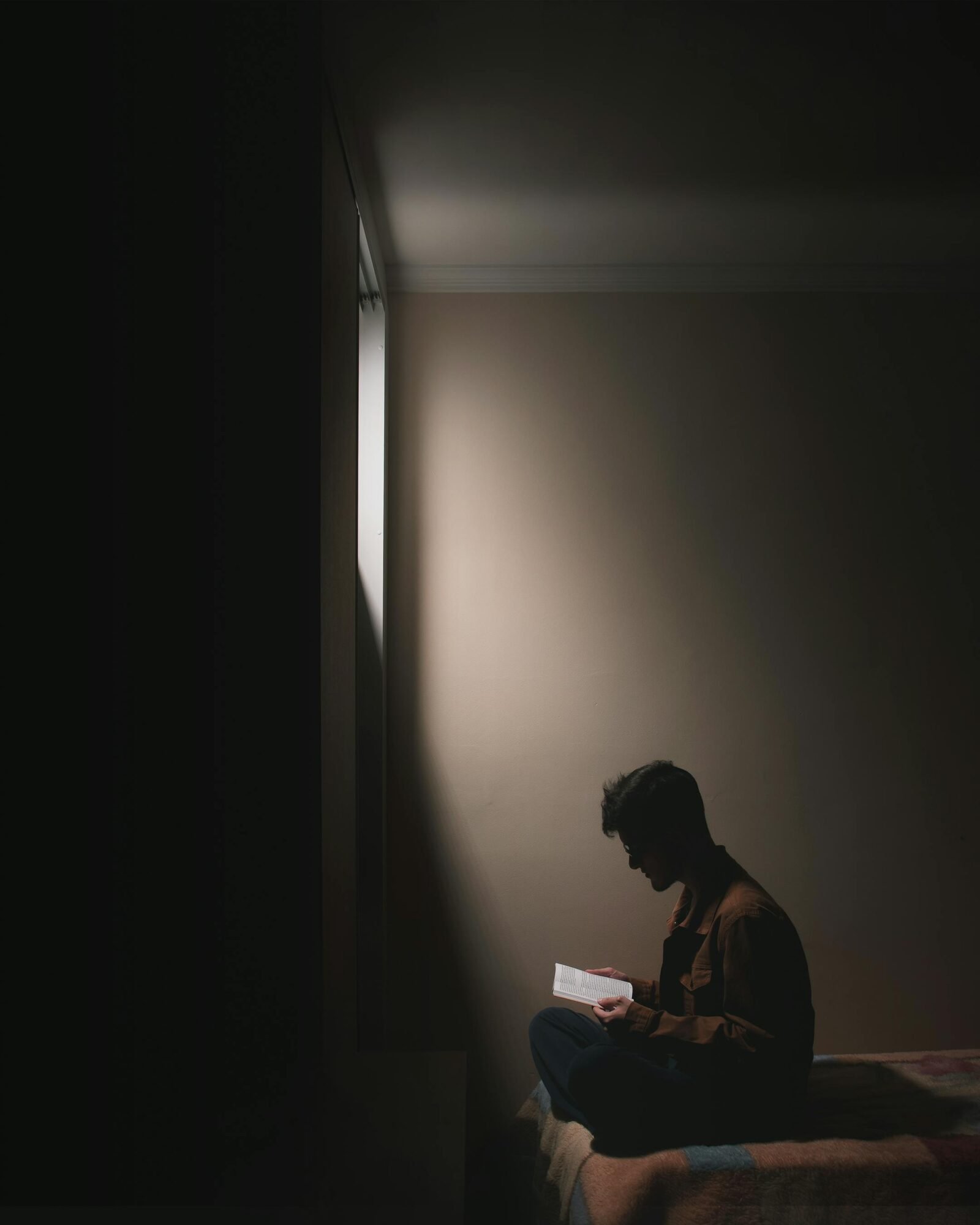 guy reading in a dark room.